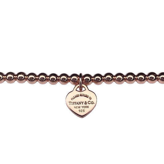 Tiffany & Co. Herzanhänger an markenlosem Kugelarmband in Roségold