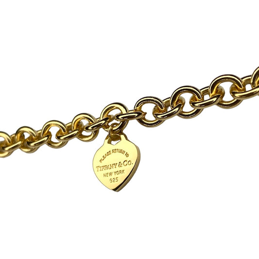 Tiffany & Co. link bracelet with heart pendant in gold